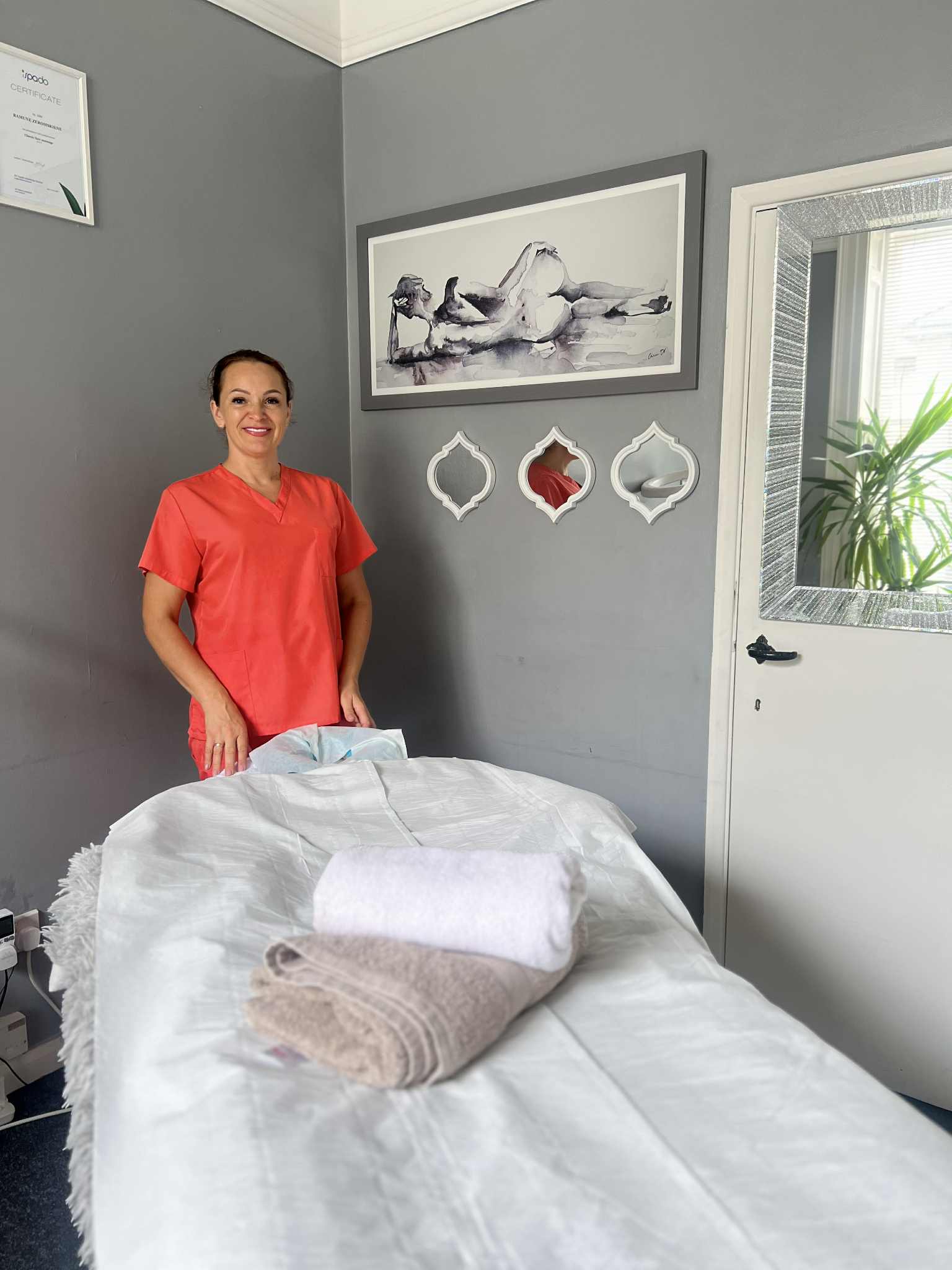 R&Z Massage therapist smiling in treatment room